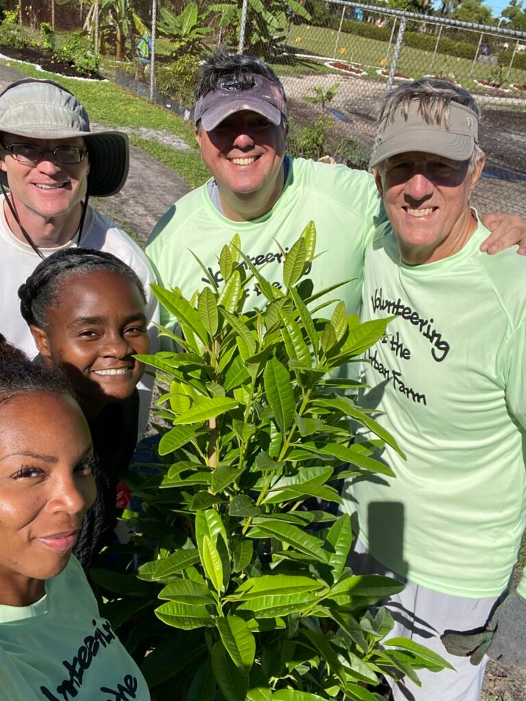 A group of volunteers celebrating the harvest to fight food insecurity.