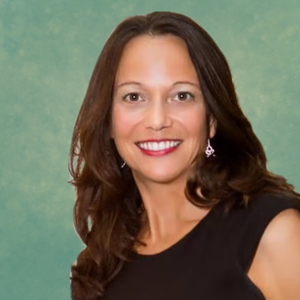 Headshot of Diana Reese, smiling, wearing a black top with a light background.